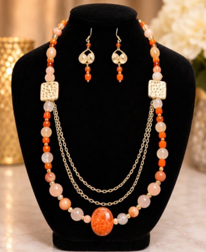 Coral Sunset layered necklace set on the studio table